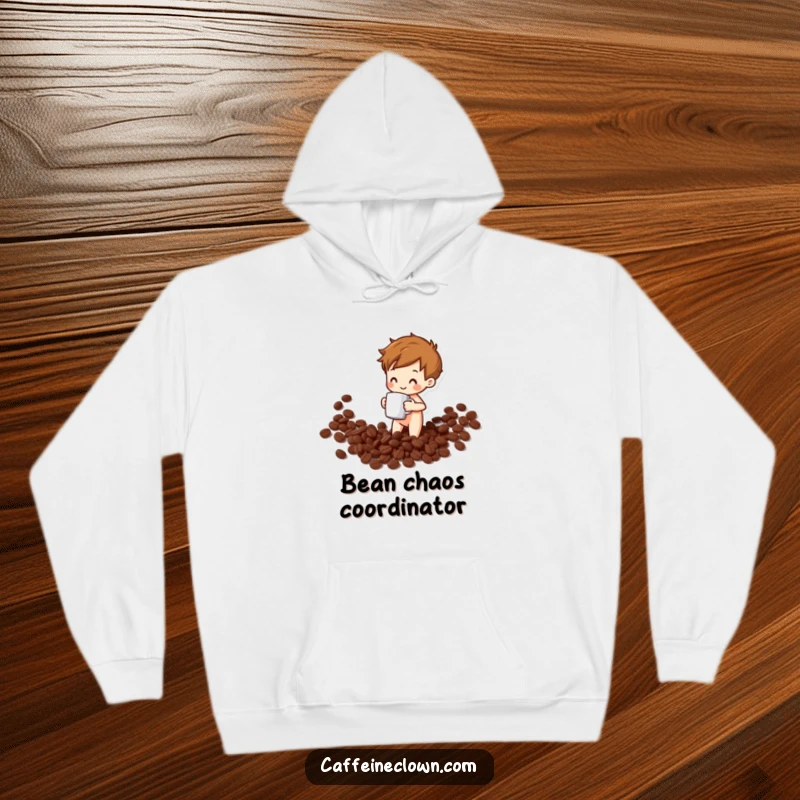 Funny hoodie illustrating a happy character spilling coffee beans while holding a mug, embodying relatable morning mishap humor.