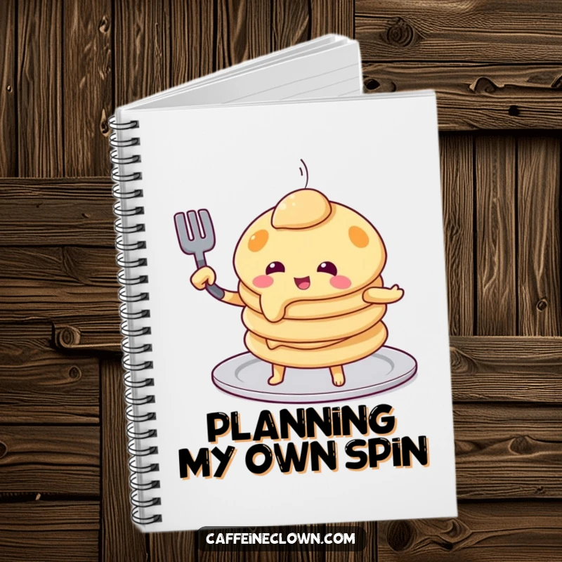 Funny pancake flip notebook cover with a playful pancake character attempting to flip itself using a spatula, a humorous stationery item.