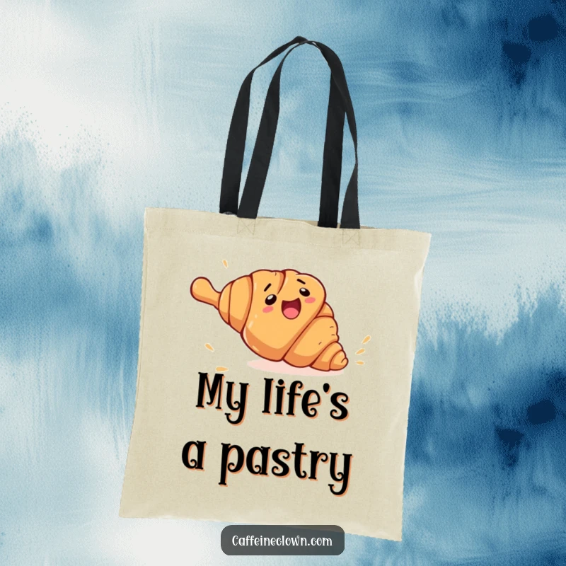 Funny croissant rolling tote bag showing a clumsy croissant character fleeing from a giant rolling pin, a practical and humorous accessory.
